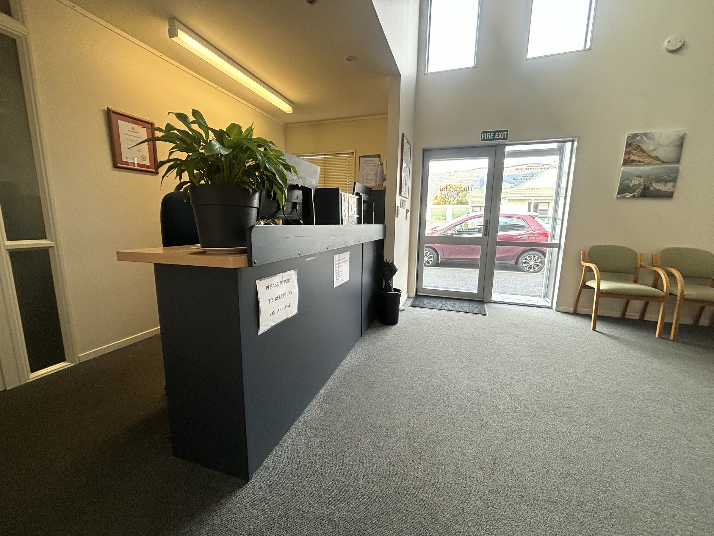 Reception counter with the main entry and daylight beyond